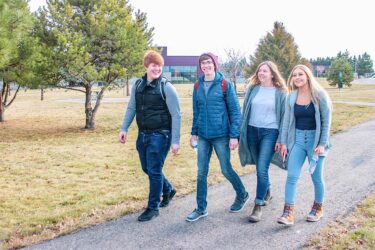 a group of students walking down a path