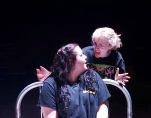 two theatre students acting on stage