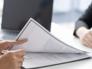 a persons hands on a printed resume