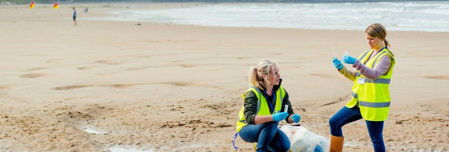 two women work on a beach