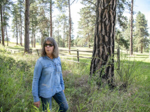 a woman walks through a forest