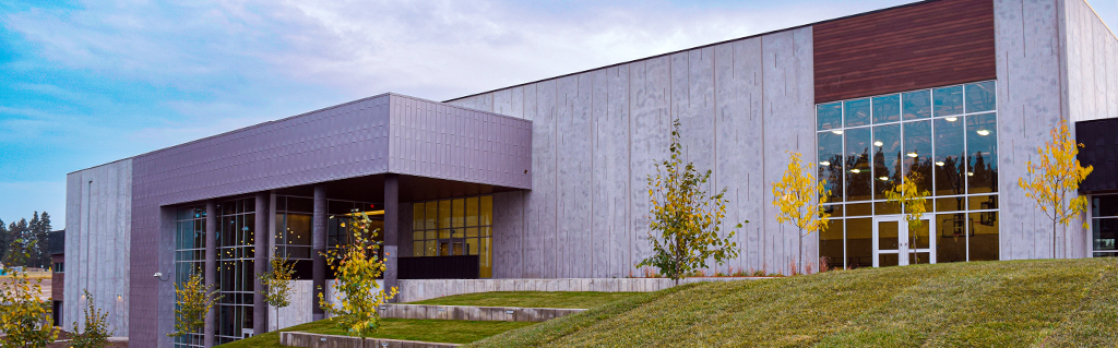 the back of the wachholz college center with trees and an outdoor amphitheater